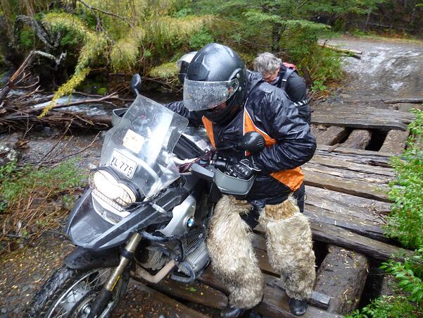 Customer geared up with winter motorcycle gear while crossing a bridge in Patagonia.