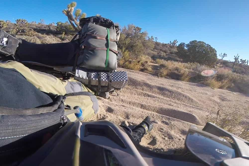 POV shot of Garrett's boot trapped under his bike after a spill. 