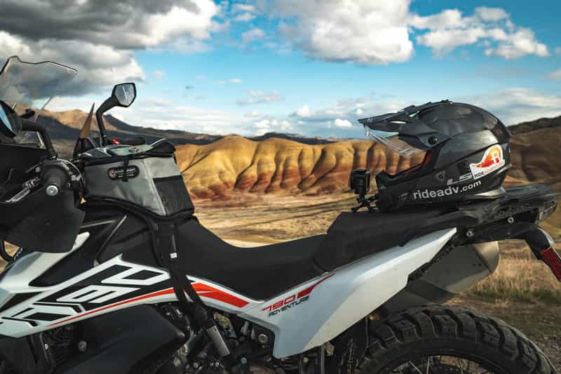 Motorcycle with Giant Loops tank bag with a backdrop of beautiful painted hills in Oregon.